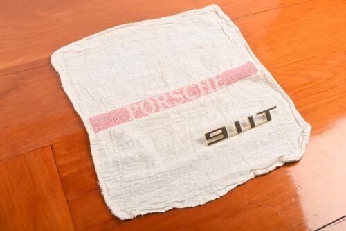 911: A '911 T' gold badge with PORSCHE tool kit cloth