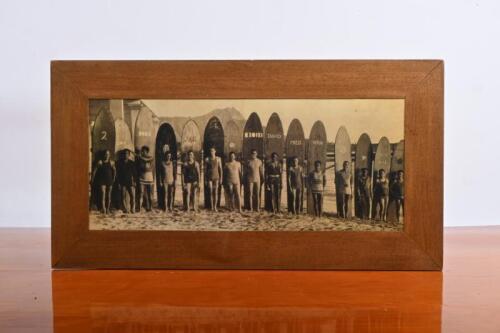 SURFING: A reproduced vintage black and white image of surfers and longboards. Possibly taken in Hawaii
