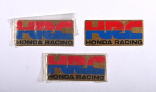 HONDA RACING: Three 'HRC HONDA RACING' gold plaques
