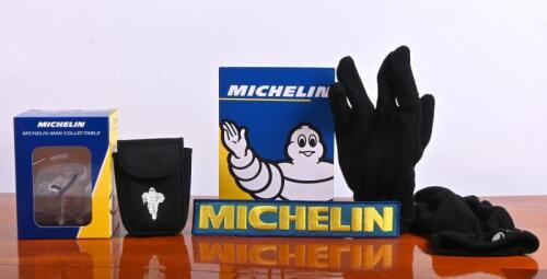 MICHELIN: A group of Michelin collectibles and items. Michelin Man figurine, 'MICHELIN' cloth badge, black Michelin gloves