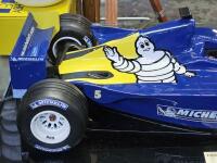 MICHELIN: A rare large model of a Michelin branded F1 car, on presentation base with perspex case and inscription plaque reading 'Formula One World Championship 2003, Australian Grand Prix',car approx. 72cm long, 29cm wide - 2