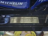 MICHELIN: A rare large model of a Michelin branded F1 car, on presentation base with perspex case and inscription plaque reading 'Formula One World Championship 2003, Australian Grand Prix',car approx. 72cm long, 29cm wide - 5