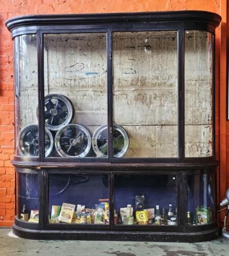 DISPLAY CASE: An impressive antique bow front shop display case. Measures 250cm high, 245cm wide, 45cm deep
