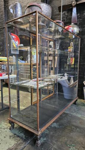 DISPLAY CASE: A wide upright antique timber and glass display case. Makers plaque of 'DUFF'. Measures 147.5cm wide, 153cm high, 56cm in depth