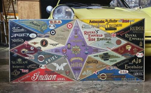 MOTORCYCLE COLLAGE: A metal sign made by pin striper Vic Bogner in the 1970's with a collage of motor cycle water slide decals including manufacturers Indian, Norton, Rudge, Vincent. Measures 125cm wide, 58.5cm high overall