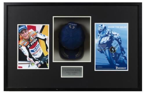 ROSSI: A box frame featuring Valentino Rossi, 'World Champion 2001 - 2003'. Signed Valentino Rossi MICHELIN PODIUM cap