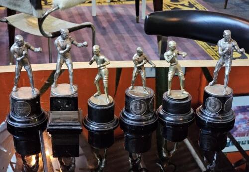 BOXING TROPHIES: A group of six early boxing trophies. Some with medallions to ebonised