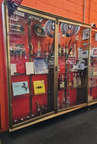 DISPLAY CASE: An antique brass double door, shallow display case. measures 198 cm high, 182cm wide, 61.5cm deep