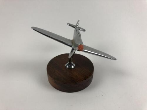 SPITFIRE MASCOT: A chrome Spitfire mascot on wooden base