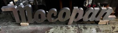 MOCOPAN: A circa 1980's stainless steel 'Mocopan' coffee house sign
