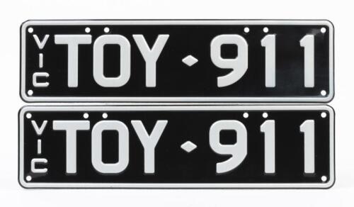 911: A black and white slimline Victorian number plate - 'TOY 911'sold with rights to display.