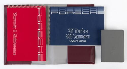 PORSCHE OWNERS WALLET: A PORSCHE Driver's wallet with 1986/1987 PORSCHE 911 Turbo 911 Carrera Owner's Manual with inserts. Warranty & Maintenance booklet, PORSCHE 'FACT BOOK' booklet
