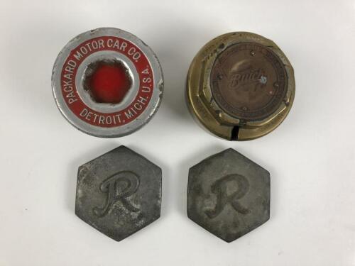 WHEEL HUB COVERS: A collection of wheel hub covers. Buick and Packard