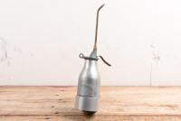 OIL BOTTLE: A 1920s - 1950s aluminium alloy 300 ML 'Reilang' oil bottle with bolt on base