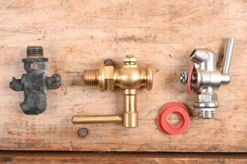 RADIATOR TAPS AND WASHERS: Two new old stock and one used radiator drain taps and washers