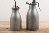 OIL BOTTLES: Two 1920's -1950's aluminium alloy 'Reilang' oil bottles of different sizes - 2