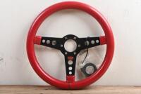 SAAS: A SAAS three spoked, red leather rimmed steering wheel