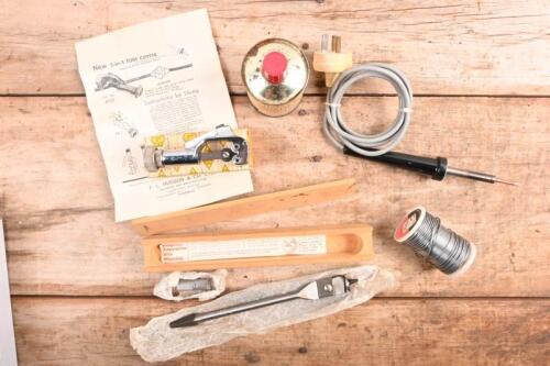 TOOLS: A collection of tools including tube cutter, Ridgway expanding drill bit, soldering iron, "Baker's" "BURNAX" liquid flux and roll of solder