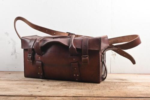 TOOL BAG: A veteran and vintage brown solid leather tool bag with shoulder strap