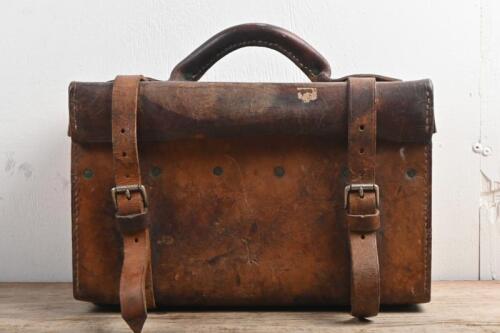 TOOL BAG: A veteran and vintage black solid brown leather tool bag