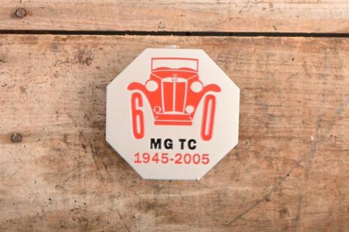 MG TC: A 60th anniversary MG TC commerative badge, new with mounting screws.