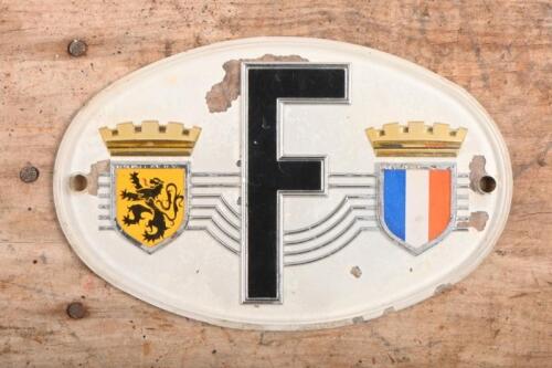 57B · FRANCE: A plastic form French plate with emblems either side