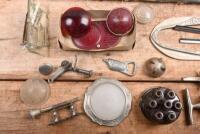 CAR PARTS: A box of car parts predominantly for American cars. 1920s - 1940s small dash gauge surround, interior roof light cover, glass mirror, rear tail lenses - 3