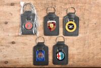 KEYRINGS: A group of five keyrings for European marques including 'ALFA ROMEO', 'LAMBORGHINI', 'MASERATI', 'OPEL' & 'PORSCHE'