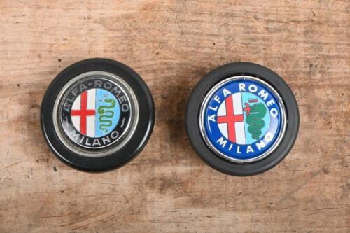 85C · HORN BUTTONS: Two Alfa Romeo horn push buttons, one with black logo the other with blue