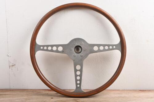 STEERING WHEEL: A wood rimmed, vintage steering wheel. Three spoke