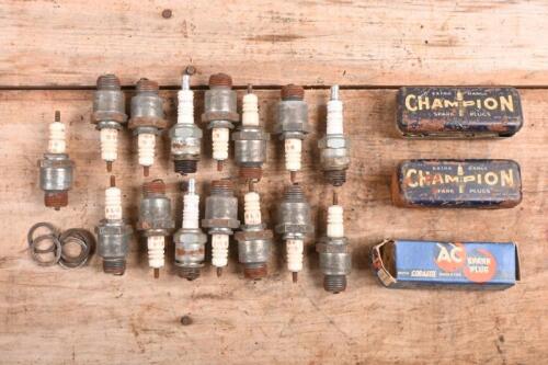 SPARK PLUGS: A group of spark plugs. K.L.G, Champion & AC Spark Plugs