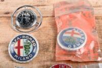 ALFA ROMEO: A group of six Alfa romeo plastic badges including one NOS in original packet part no 2400.51012 - 3