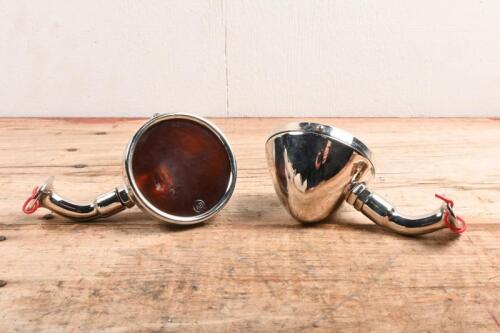 INDICATOR LAMPS: A pair of indicator lamps with adjustable bases. Amber glass