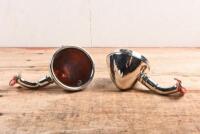 INDICATOR LAMPS: A pair of indicator lamps with adjustable bases. Amber glass