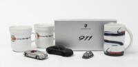 PORSCHE: A collection of Porsche related items including a 1:43 Schuco Porsche 356, small 356 desk ornament, 991 black pewter Porsche model with box along with three mugs