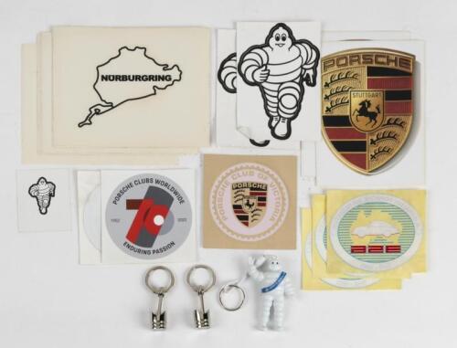 STICKERS: A group of stickers and keychains including a number of Nurburgring stickers, Porsche 356 Register stickers, Porsche emblem stickers and three keychains, Michelin and Piston keychain.