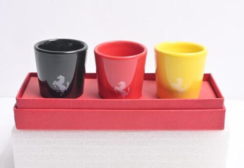 FERRARI: A set of three Ferrari Official Product espresso cups in the colours of black, red and yellow