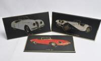 JAGUAR: Three retro plastic plaque desk signs featuring various Jaguar models. '1937 SS 100 OPEN TWO SEATER', 'XK 120 1948', '"E" TYPE 1961' desk signs. Made for UNIPART LEYLAND CARS LTD