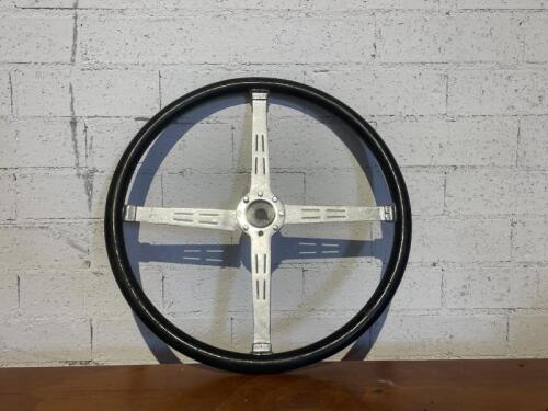 STEERING WHEEL: A four-spoke steering wheel to suit a vintage car [Location: Sydney]