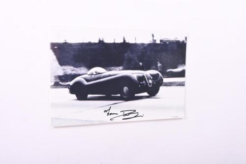 XK120M: Two items related to the Jaguar XK120M of Norman Dewis. Picture of Norman Dewis driving the XK120M, image signed by Dewis