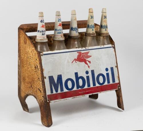 MOBILOIL: A Mobiloil 'Vacuum Oil Company' 10 bottle oil rack with enameled sign and five one pint glass oil bottles with various Mobil tin tops