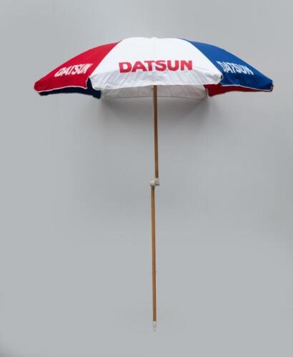DATSUN: An original and likely unused factory Datsun beach umbrella ex Reg Hunt 1983, with original delivery label and in original bag