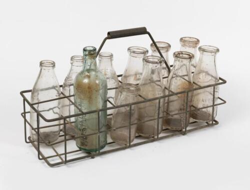 MILK BOTTLES: A 12 bottle carrier including various milk bottles and cordial bottles such as J.Kilpatrick Malvern pint,