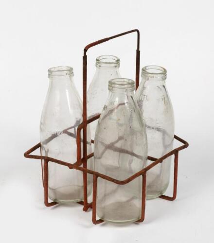 MILK BOTTLES: A wire four bottle carry basket including four glass 600ml milk bottles