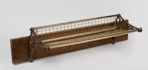 NSWR: A New South Wales Railway luggage rack with cast ends and brass wire, mounted to timber backing