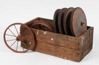 PEDAL CAR: A selection of pedal car or scooter wheels within a wooden crate