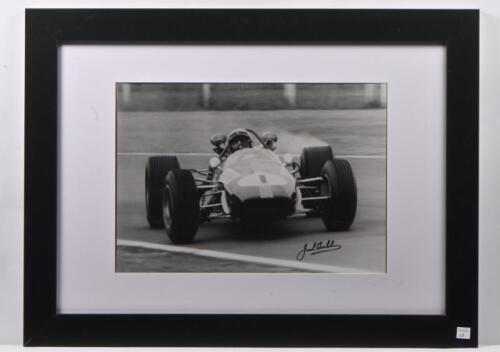 BRABHAM: A framed black and white photograph of Jack Brabham's BT19, autographed to lower right by Brabham.&nbsp;