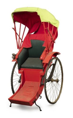 RICKSHAW: A full sized 20th&nbsp;century oriental rickshaw in red with green fabric roof with hand woven driver hat