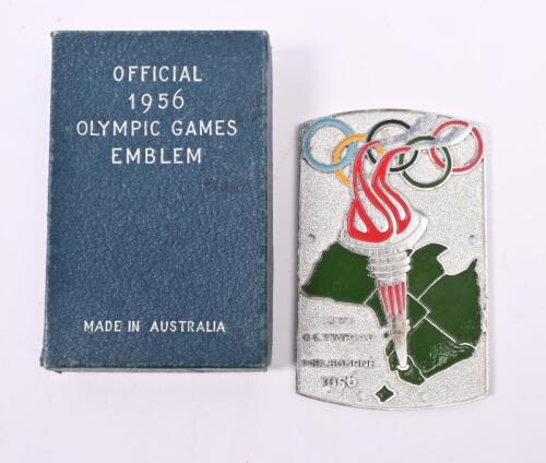 1956 OLYMPICS: A boxed enameled Melbourne 1956 Olympics emblem badge by Stream Lux Australia. 6.5cm wide 10cm high. With mounting screws.