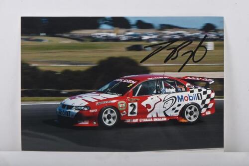 BRIGHT: A colour image on photographic paper of Jason Bright in a HSV VX Holden Commodore at Phillip Island. Jason Bright signature